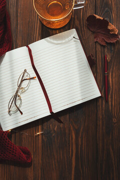 Autumn flat lay with open notebook, cup of tea