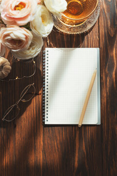 Cozy morning planning with notebook, pen, and coffee