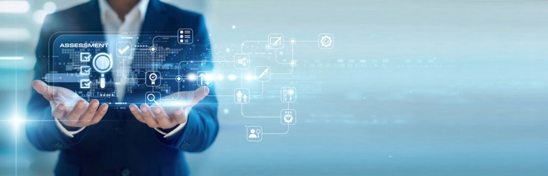 HR manager handhold virtual screen for candidate Assessment metrics while working on laptop to evaluate talent. Comprehensive performance analysis and professional skill level verification.