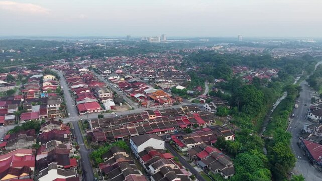 Aerial view captures a quiet residential neighborhood. Red tiled roofs line orderly streets at Kampar