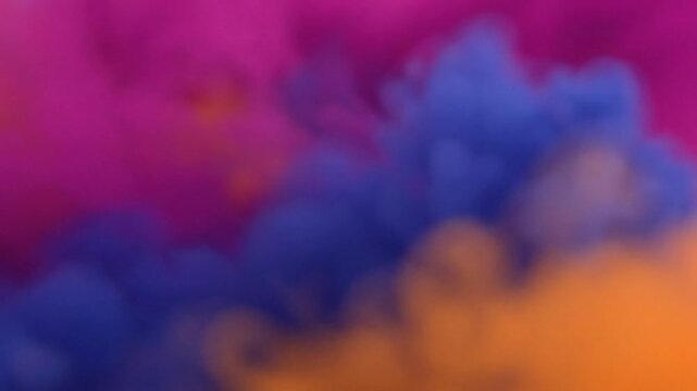 Abstract Background of Vibrant Pink Blue and Orange Smoke Clouds Mixing Together in Slow Motion