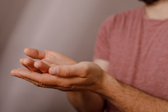 Close-up shot of a person's open palms held upwards, ready to receive