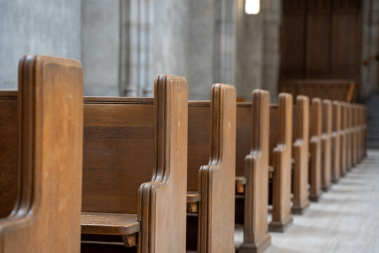 Rows of wooden pews inside a church.