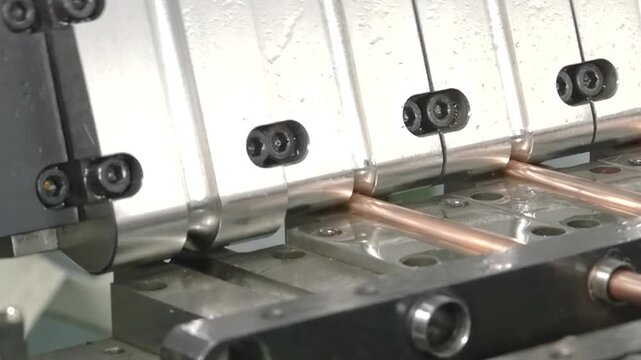 In this close-up look, copper tube parts are expertly crafted for industrial air conditioners. Witness the precision and detail of each phase in slow motion, showcasing the power of machinery.