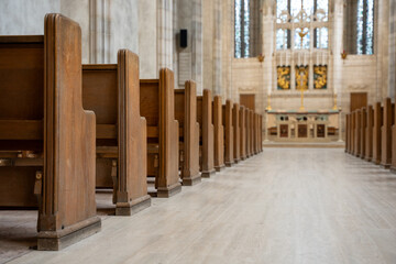 Fototapeta premium Close up view of wooden church pews and aisle.