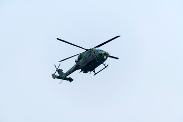 Fototapeta premium Combat Helicopter is flying on isolated blue sky