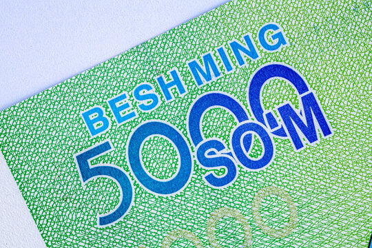 A 5000 Uzbek soum banknote. The reverse side depicts the parliament building in Tashkent, and the obverse side depicts the national emblem of the Republic of Uzbekistan.