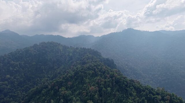 Aerial view reveals lush green mountains with dense forest at Lenggong, Malaysia