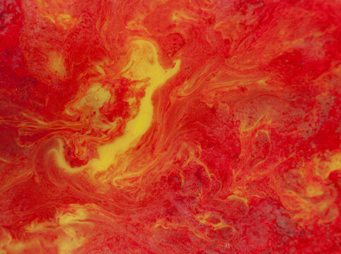 Swirling patterns of red and yellow colors on a surface