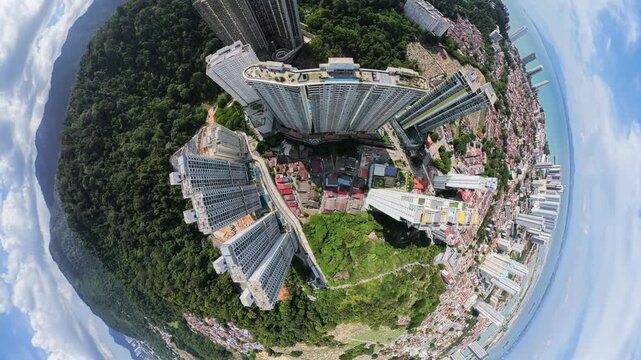 Aerial perspective of tall apartment buildings surrounded by lush green landscape, showcasing urban development