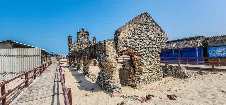 Wide-angle view of the abandoned St. Antony's Church ruins with surviving coral stone masonry, a historic landmark in the ghost town of Dhanushkodi
