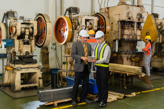 Factory Manager And Quality Engineer Shaking Hands After Plant Inspection Near Stamping Press
