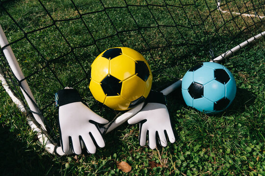 Soccer equipment arranged in goal net on grass