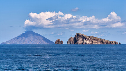 Panoramic view of the smoking Stromboli volcano and the rocky islands of Basiluzzo and Dattilo in the Aeolian archipelago © Viktor