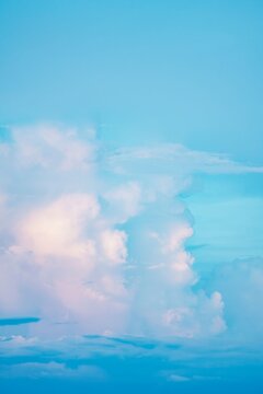 Blue sky with fluffy white clouds. Cumulus cloud formation.