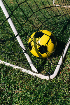 Soccer ball caught in goal net