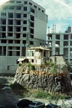 An Old House Among New Buildings