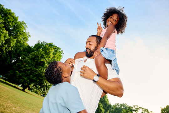 Kids enjoy playtime with their father outdoors