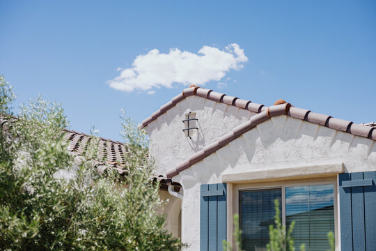 Stucco House With Tile Roof and Shutters