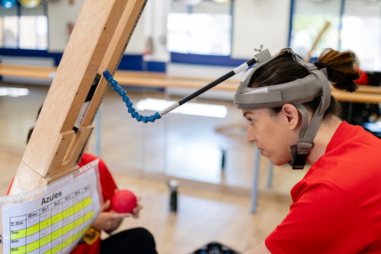 Woman using adaptive equipment for boccia training