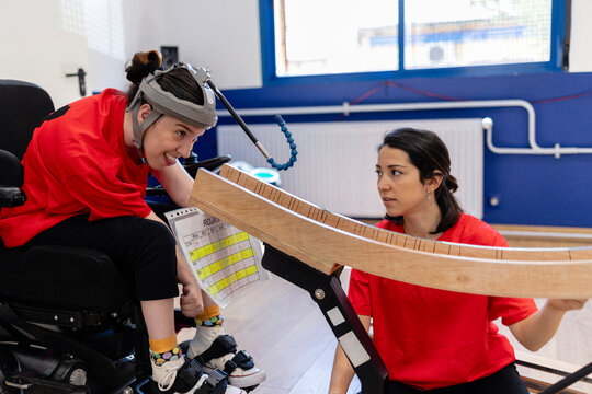 Young woman with disability playing adaptive boccia sport