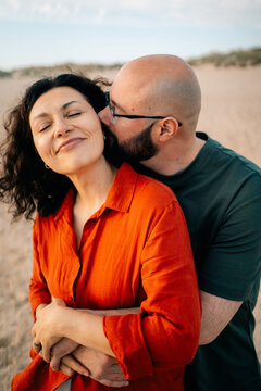 Couple Shares a Moment Together on the Beach During Sunset