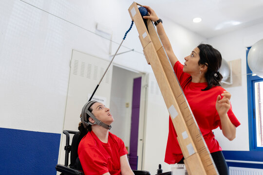 Woman in head controlled therapy with assistive technology