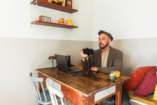 Content Creator Adjusting Smartphone on Tripod