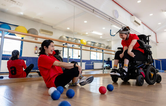 Woman with severe disability playing boccia with a friend