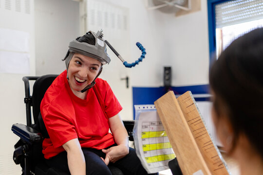 Woman with disability smiling during therapy session