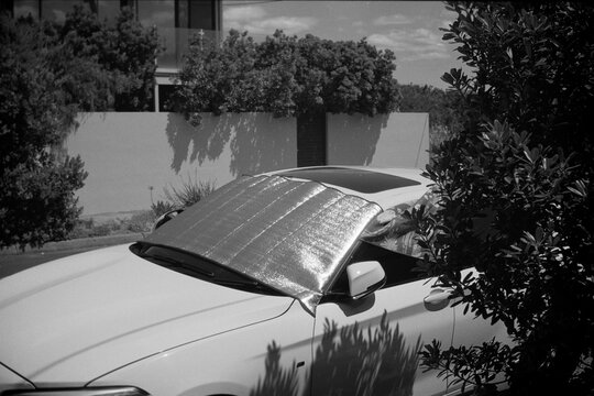 Car with Sunshade Reflector on a Bright Day
