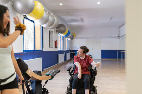 Disabled woman performing Paralympic sport with the help of equipment