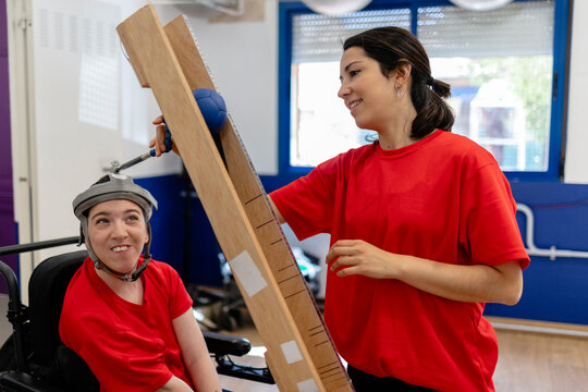 Woman with severe disability improving motor skills with therapist