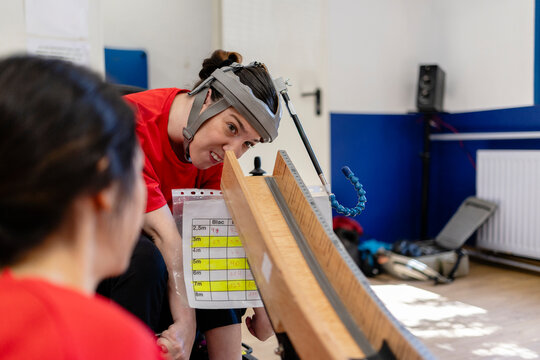 Woman with protective helmet conducting physics experiment