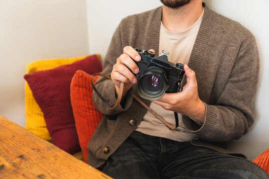 Close Up of Hands Holding Vintage SLR Camera