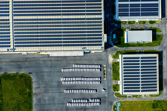 solar rooftop factory with parked cargo trailers