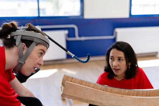 Woman with assistive device playing game with instructor