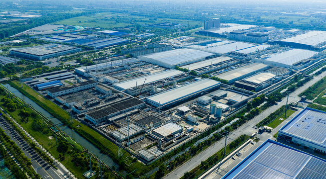 industrial park with solar rooftops beside residential city