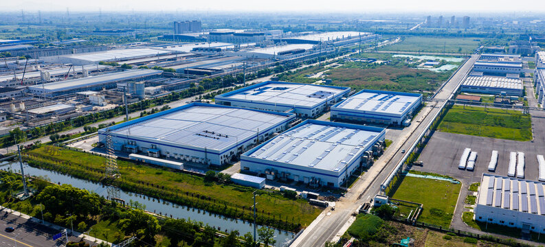 industrial park with solar rooftops beside residential city