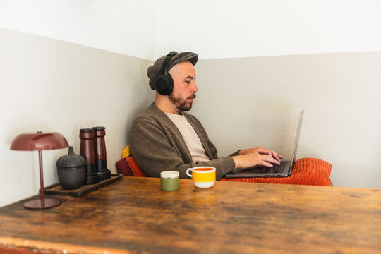 Profile of Focused Man Typing on Laptop