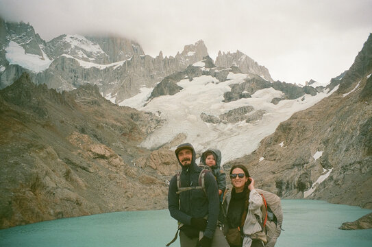Family Hiking in the Mountains With Child Under Overcast Sky