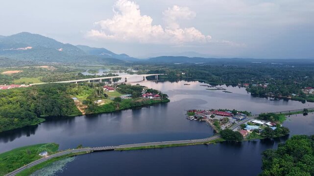 Aerial view captures a wide river winding through lush green landscapes at Tasik Raban