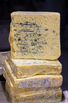 Traditional old blue cheese sold outside on market stall