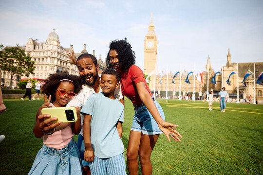 Happy parents pose for a selfie with their kids in London