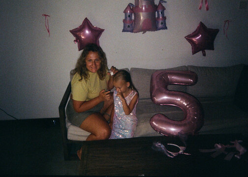 Mother and Daughter Celebrating Fifth Birthday at Home