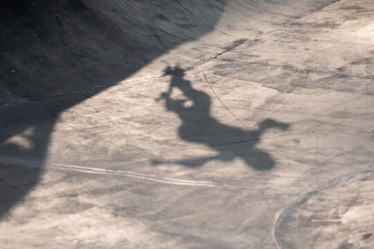 Skateboarder shadow mid-air