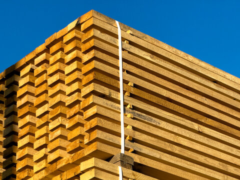 Stacked Wooden Lumber Planks Packaged for Construction