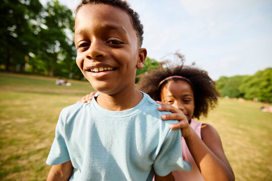 Happy kids facing the camera in a park