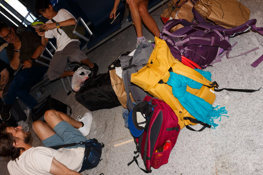 UGC Travelers Rest at Airport With Bags and Devices in Warm Weather