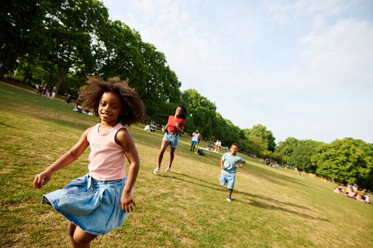 The family is playing tag in the park